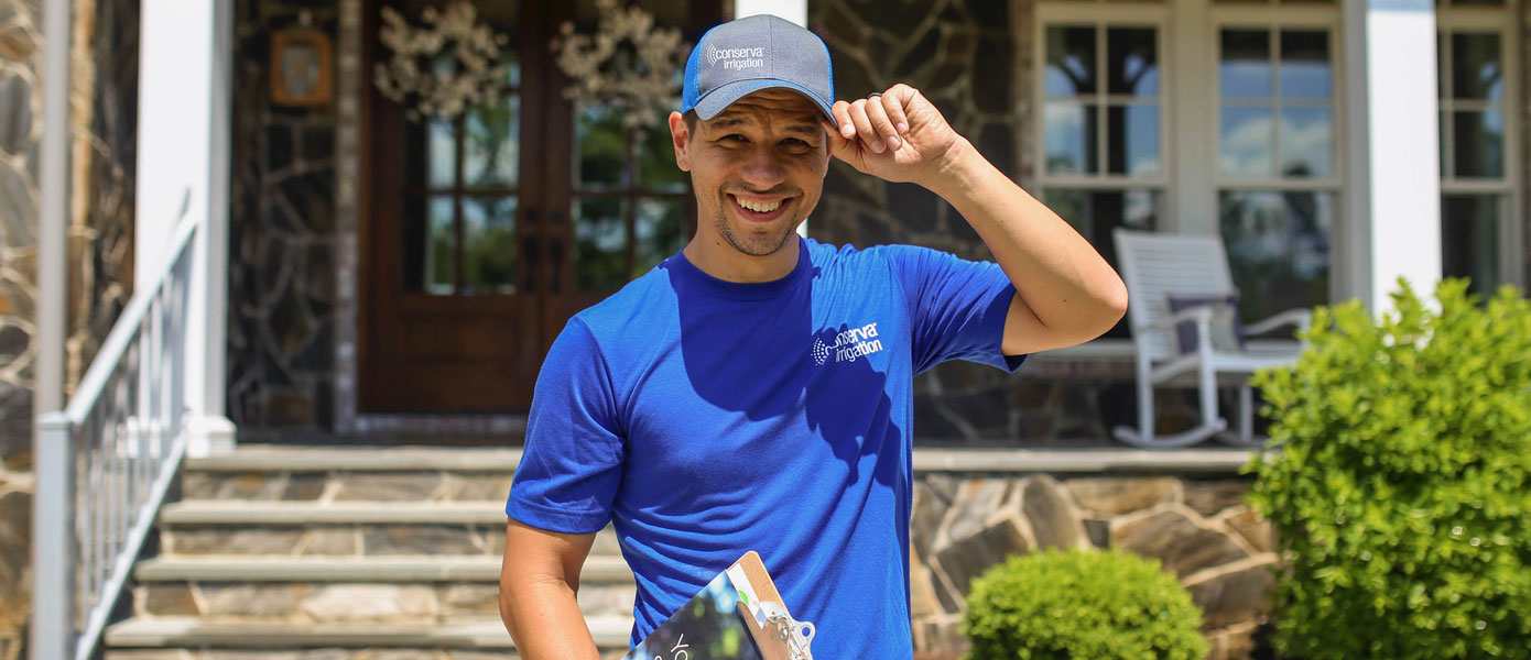 Conserva team member in front of house 