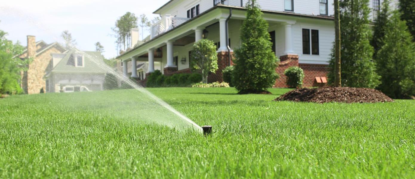 Sprinkler in front yard of home